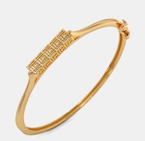 Minimal twisted rope gold bangle with a refined finish.