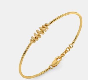 Antique-style gold bangle with embossed leaf designs.